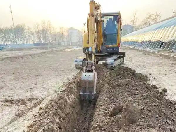 A digger at work, digging a frost-proof trench