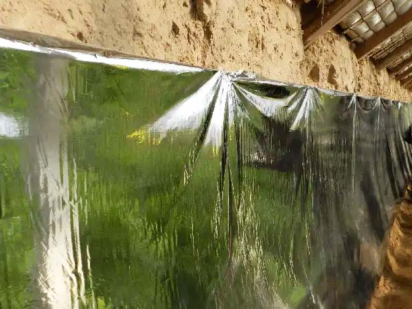 Reflective sheets hanging inside a greenhouse